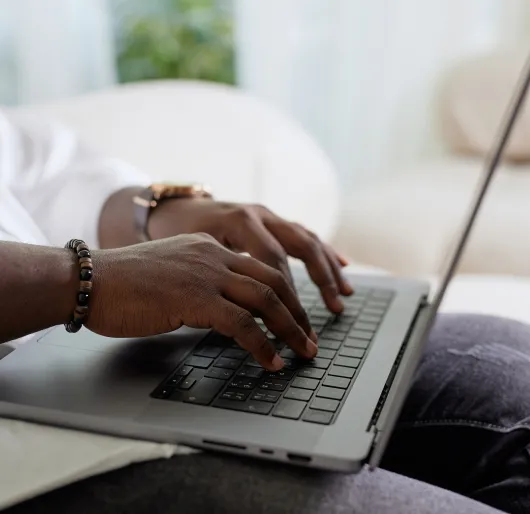 Hands typing on computer